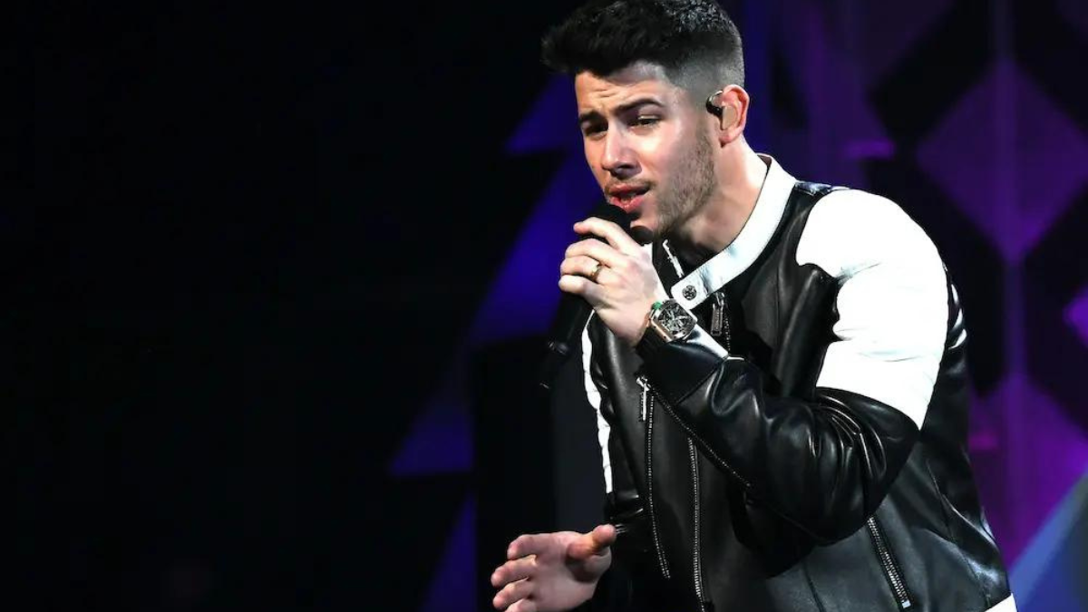 nick jonas falls backwards on stage during live performance in boston